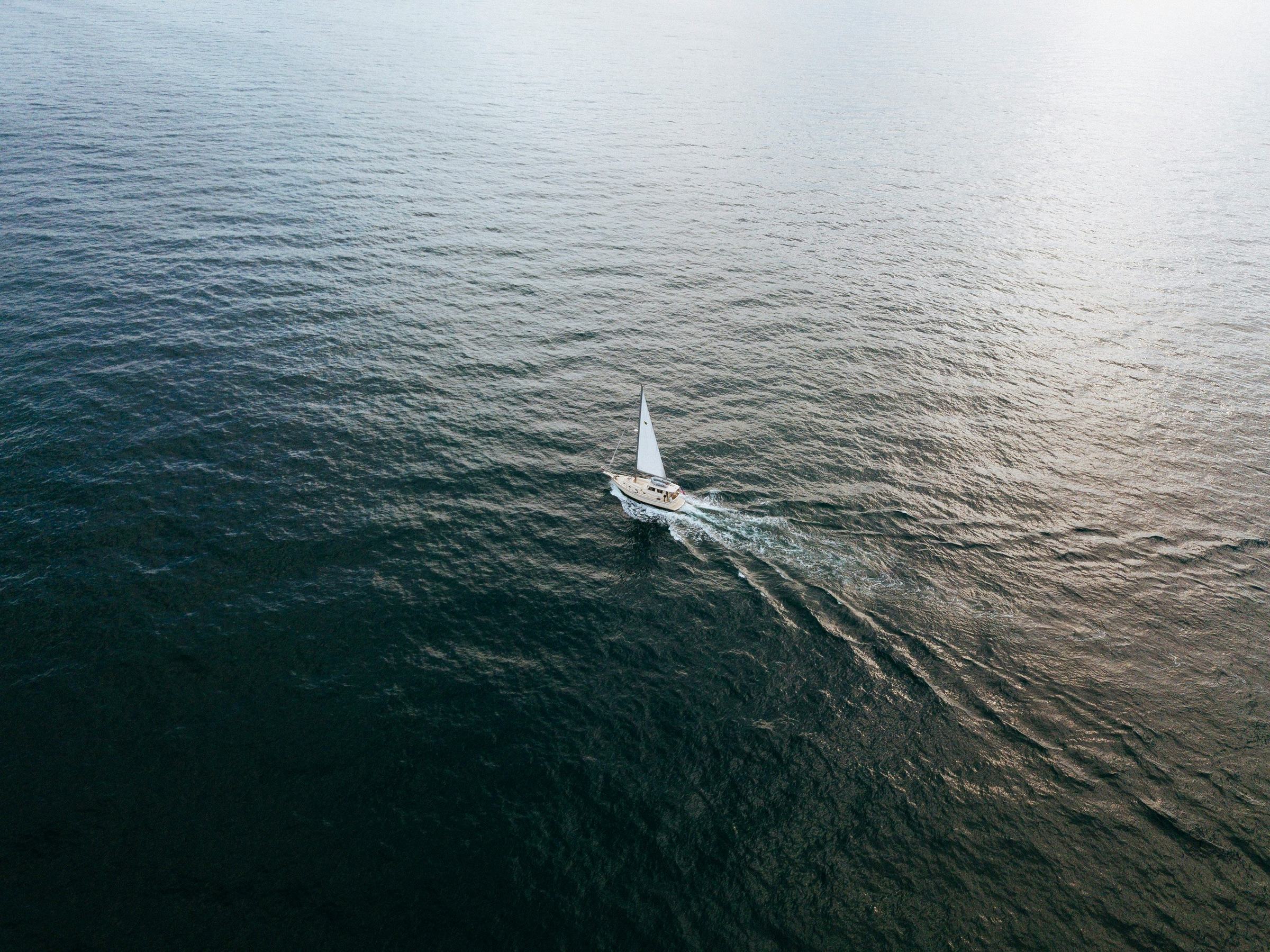 Aerial view of a sailboat underway on open water